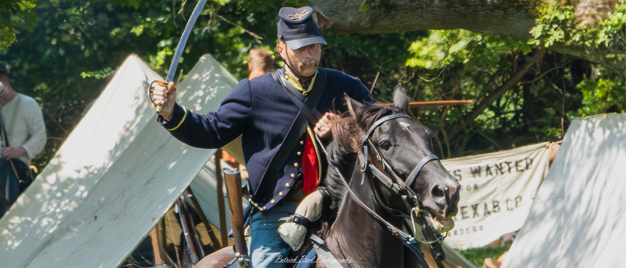 "A Union cavalry soldier from the American Civil War, dressed in a dark blue uniform, is mounted on a horse, mid-action, swinging his saber with determination. His posture is commanding, with his saber raised high, ready to strike. The horse is in full gallop, its muscles straining as they charge across the battlefield. Dust and chaos fill the scene as the soldier leads the charge, embodying the bravery and intensity of cavalry warfare during the Civil War."